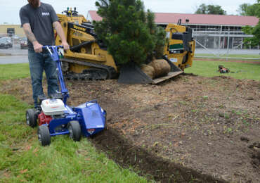 Bear Rental employee uses a bed edger.