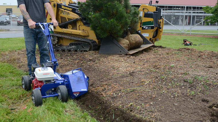 Bear Rental employee uses a bed edger.