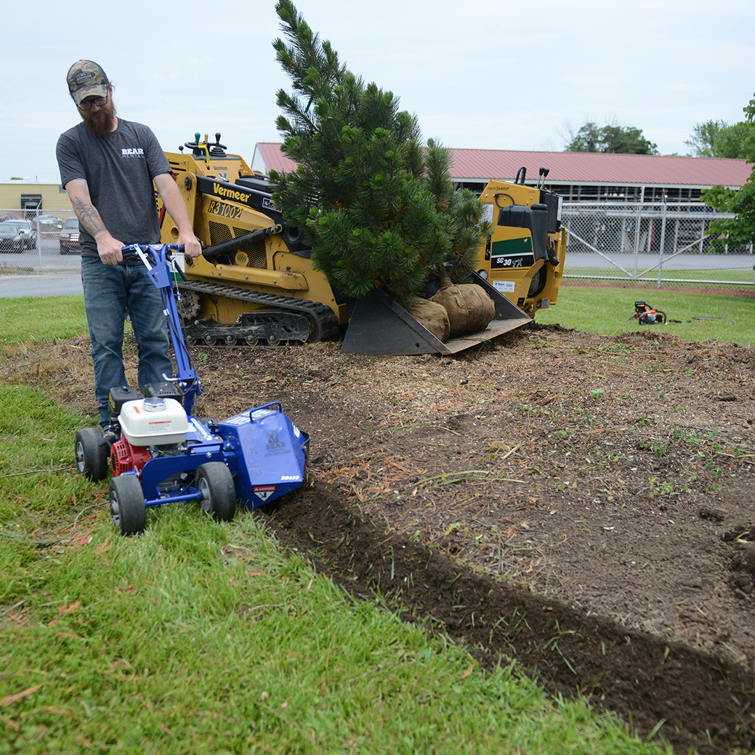 Bear Rental employee uses a bed edger.