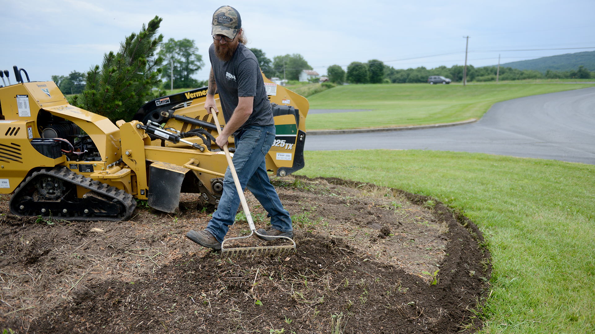 Bear Rental employee raking back from the new edge