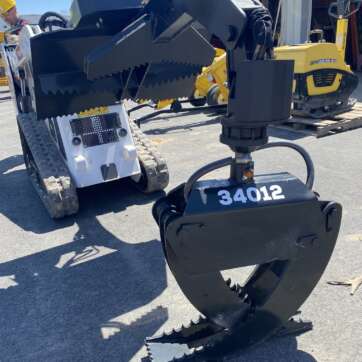 Rotating grapple for track skid steer